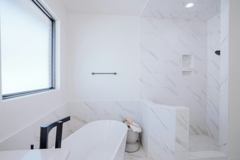 White bathroom with freestanding tub after deep cleaning