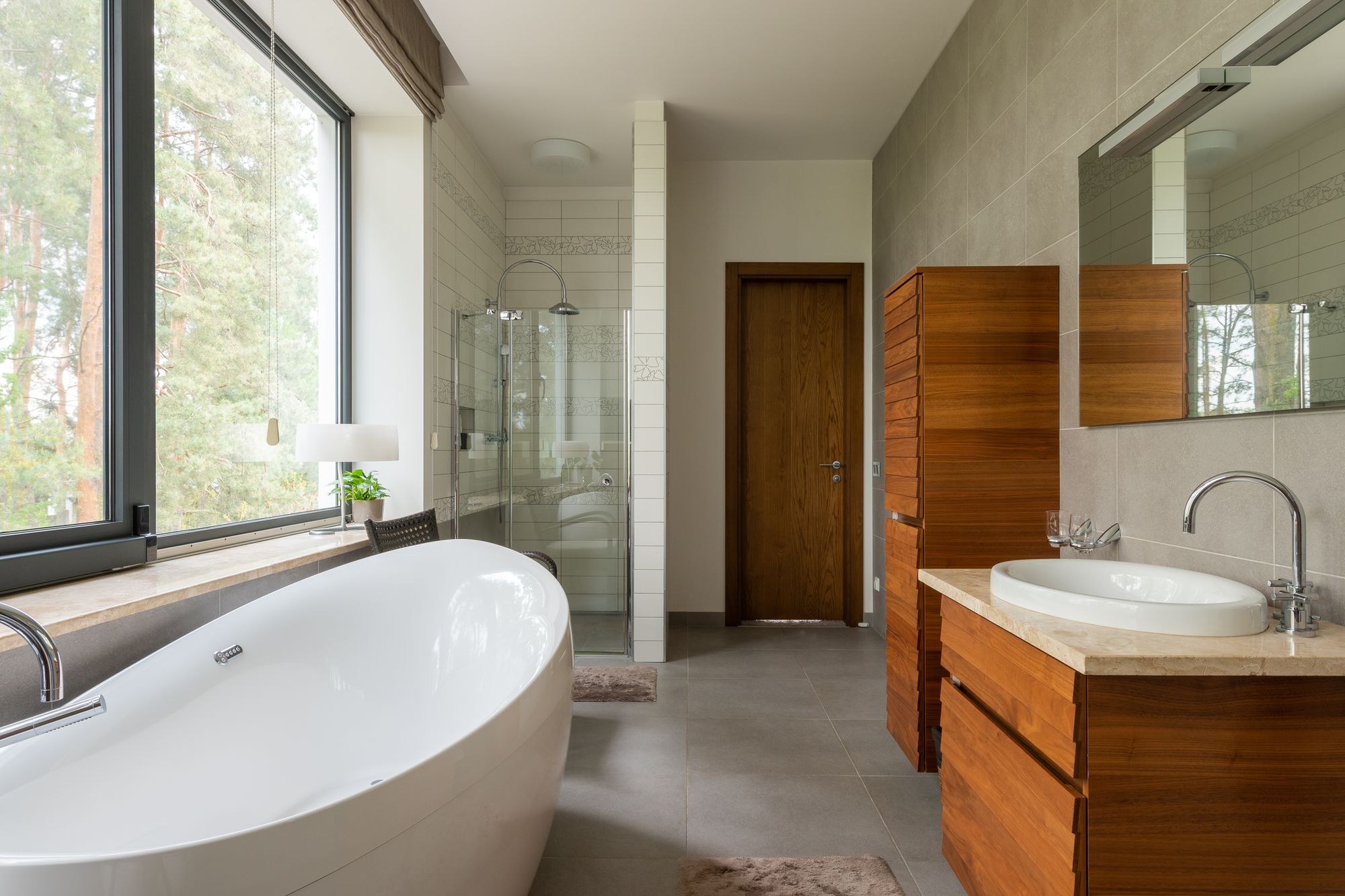 Clean bathroom with white tub and large window